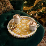 White Snowflakes on Gold round tray in a styled home setting