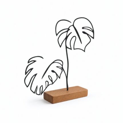 Monstera Plant Outline Metal Table Sculpture on Wooden Base on a white background